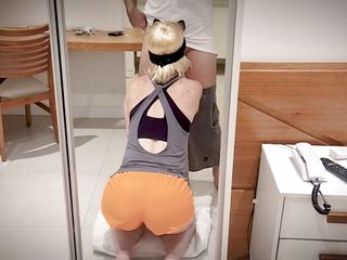 Masked blonde sucks cock kneeling and takes cumshot on her face.