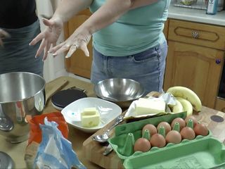 Petite woman bakes with obese granny