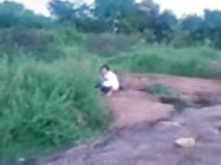Sri Lankan woman piss on a rock